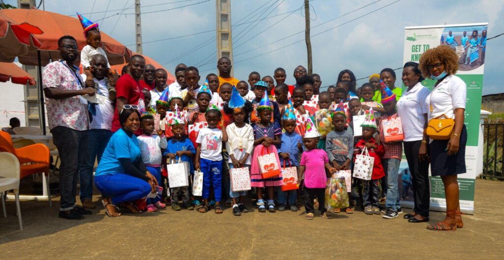 Children and ASCOA representatives displaying school materials