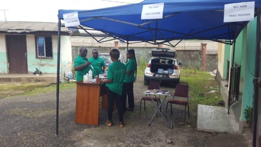 Health outreach volunteers working under a screening tent
