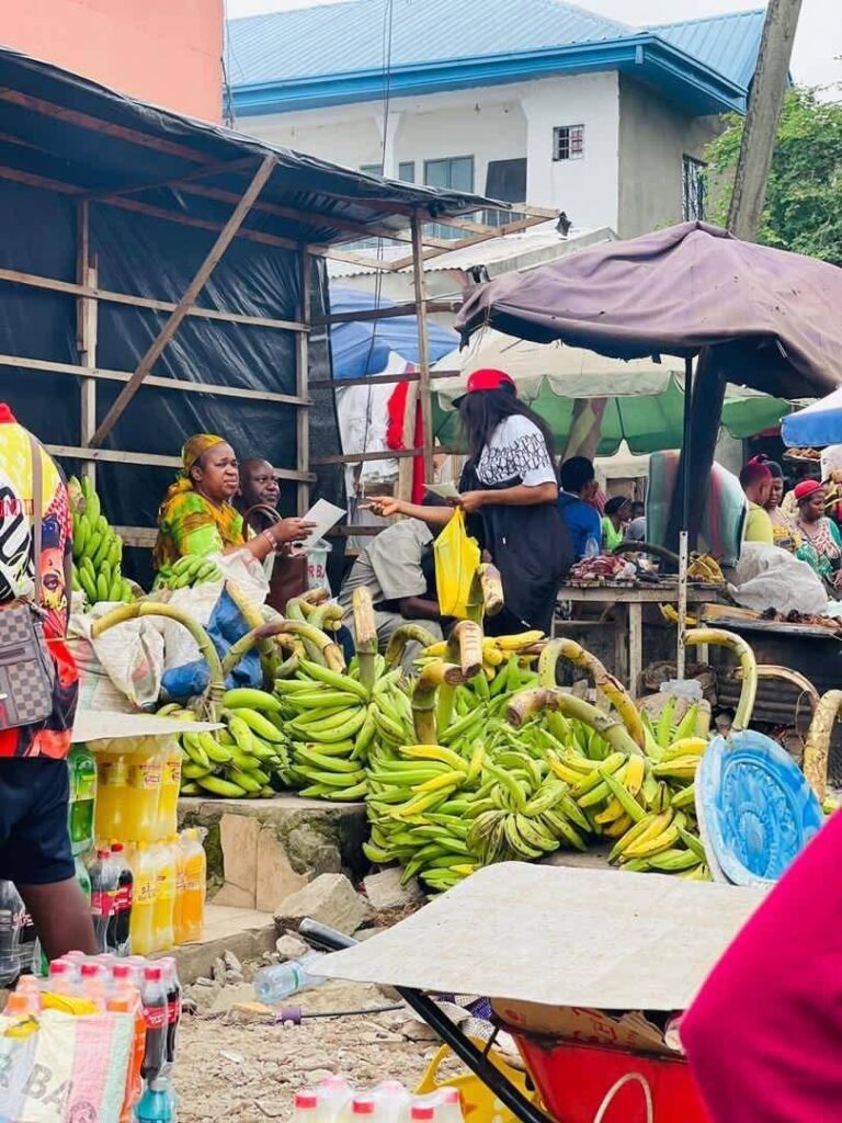An ASCOA volunteer discussing blood donation at a market stall
