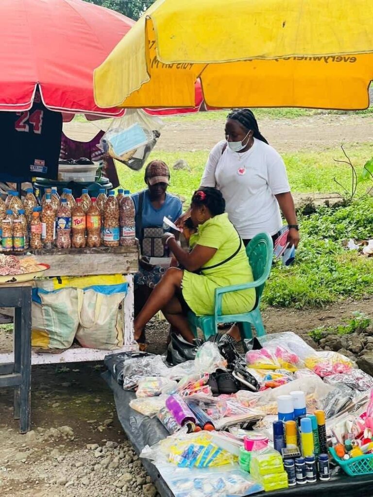 A health volunteer engaging a market trader