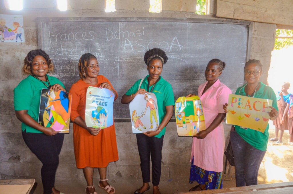 Young participants displaying colourful peace artwork
