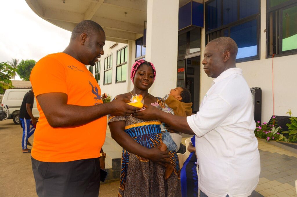 ASCOA representatives presenting support to a community member
