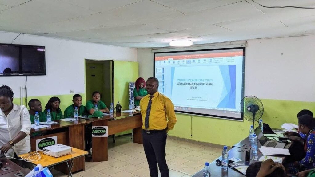 A participant speaking at an ASCOA peace education workshop